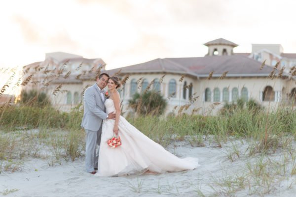 Bride and groom with the dunes and club in the background - Grande Dunes Ocean Club