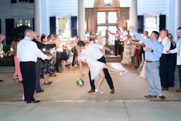 Groom dipping back bride during sparkler exit - Pine Lakes Country Club