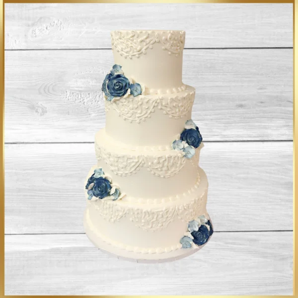 Four-tier white wedding cake with blue floral accents