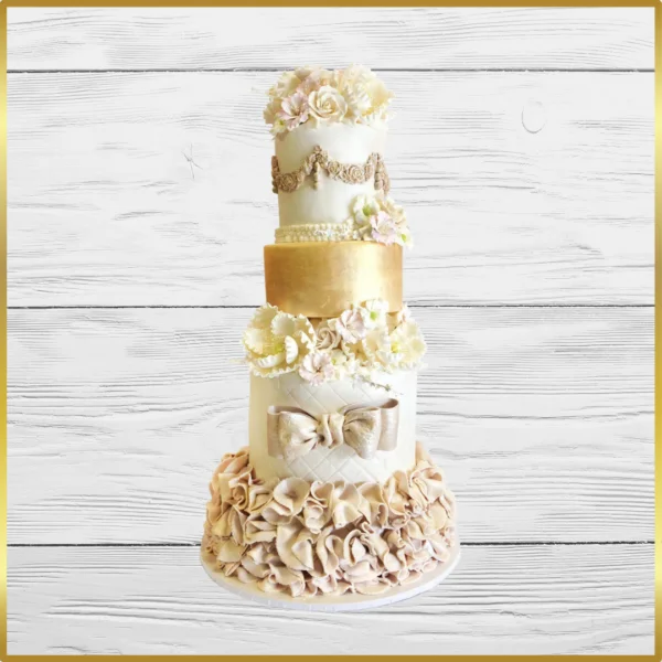 Five-tier gold and cream wedding cake with floral and bow details